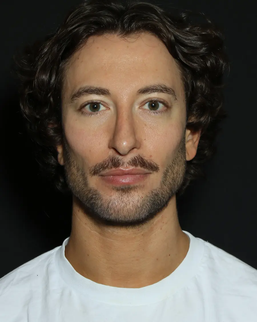 A man photographed straight on in even light